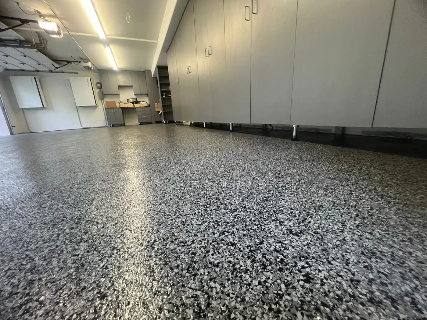 Gray flake epoxy garage floor, the kind of project our epoxy contractor clients win through Google