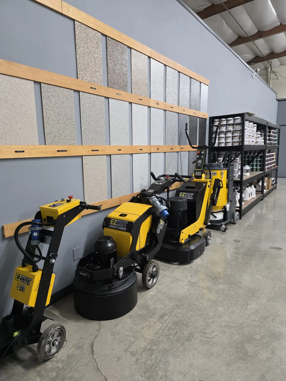 Concrete grinders lined up in a coatings showroom